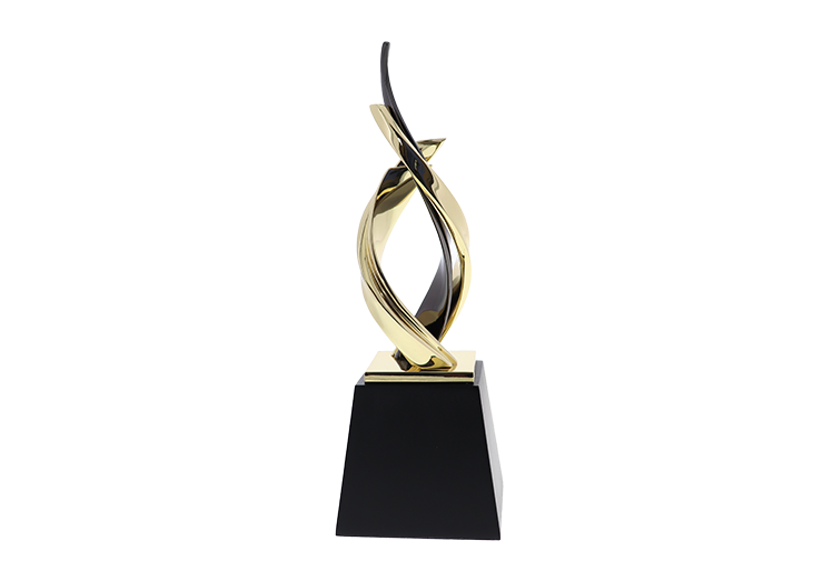 Luxury award possessing gold ribbons intertwining with one sleek black ribbon atop a black base